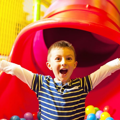 Little boy in the ball pool
